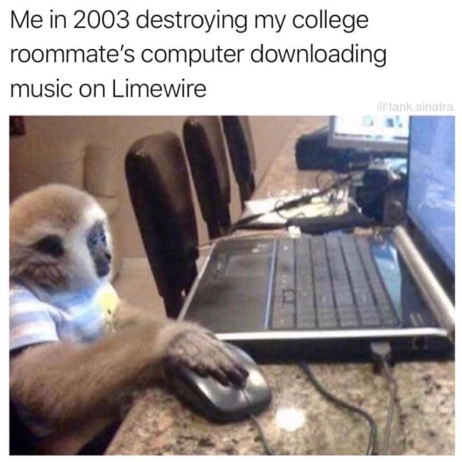 A nostalgic internet history image shows a small gibbon monkey wearing a striped t-shirt intensely gripping a mouse next to a silver laptop, humorously depicting a 2003 college student destroying their roommate's computer with malware while downloading MP3s on Limewire.