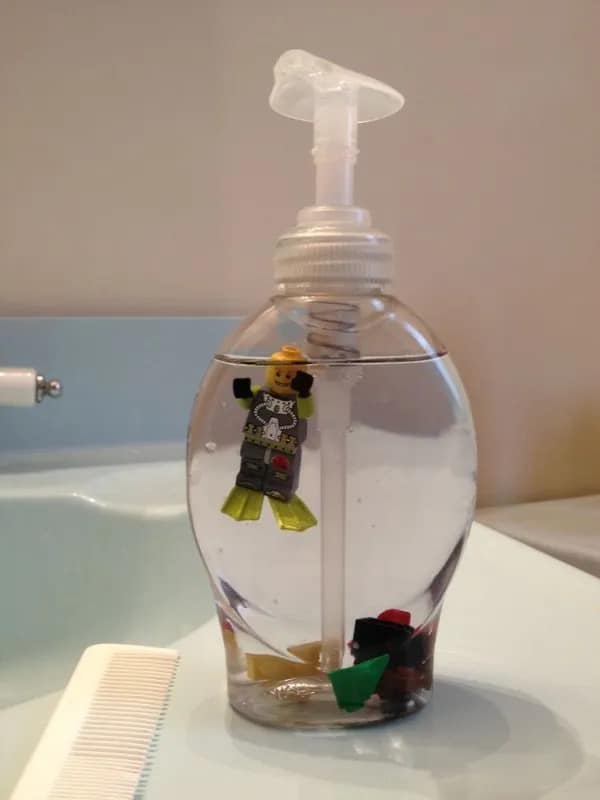 A quirky household decoration inside a meme dump shows a clear liquid soap pump dispenser bottle featuring a Lego scuba diver minifigure floating perfectly in the middle of the clear soap gel.