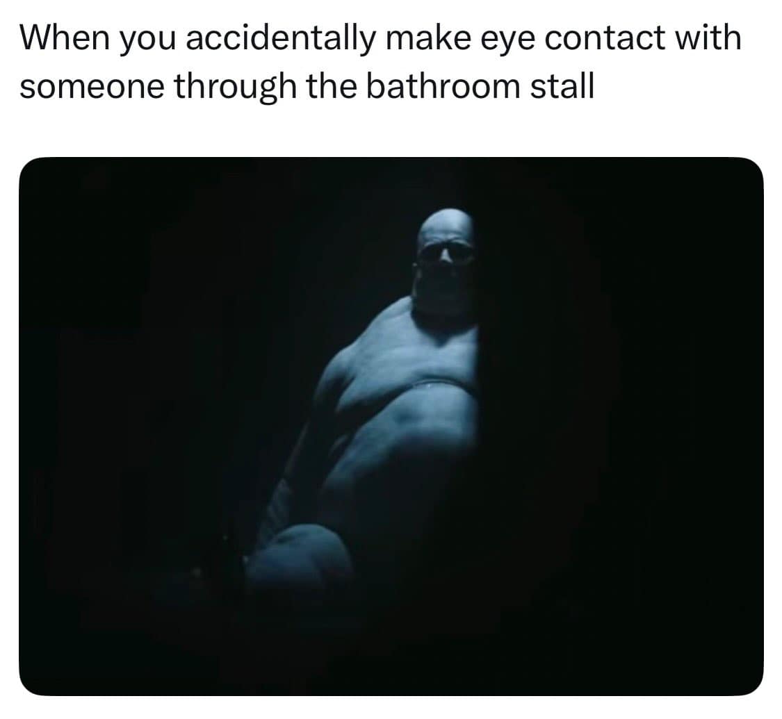A cinematic meme dump highlight showing the Baron Harkonnen from Dune peering through a sliver of light in the darkness, used to describe making accidental eye contact through a bathroom stall gap.