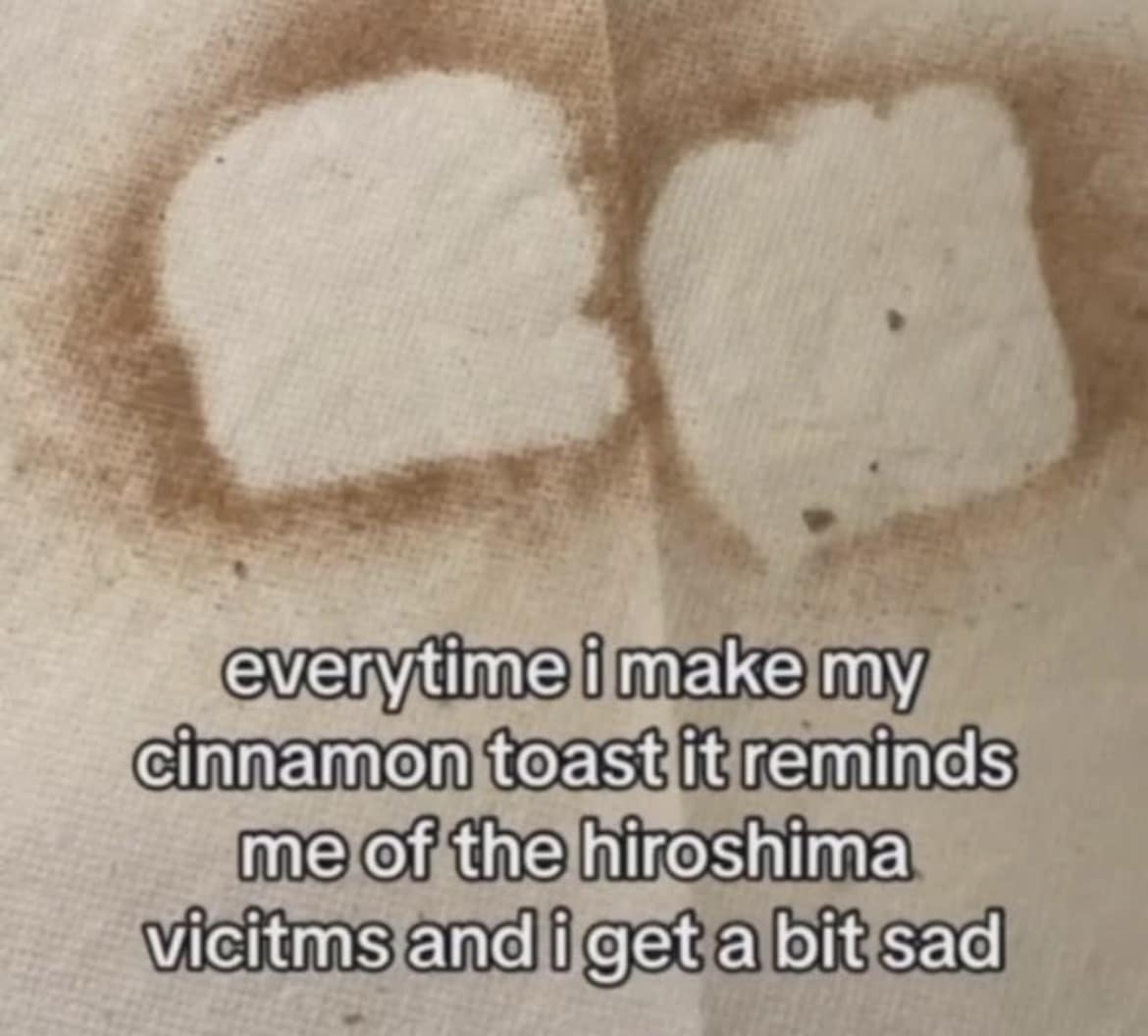 A dark and hilarious meme showing the residual brown stains of cinnamon toast on a paper towel, which the creator claims reminds them of the "shadows" of Hiroshima victims.