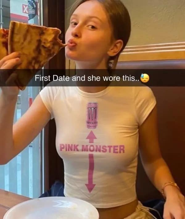 A young woman eating an oversized slice of pizza wears a custom white t-shirt referencing a Pink Monster Energy drink container in a viral relationship-themed meme dump post.