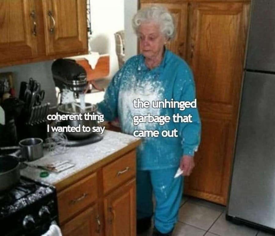An expressive kitchen photo showing an elderly woman completely covered in a massive cloud of white baking flour serves as a relatable funny meme about completely failing to voice a coherent thought clearly.