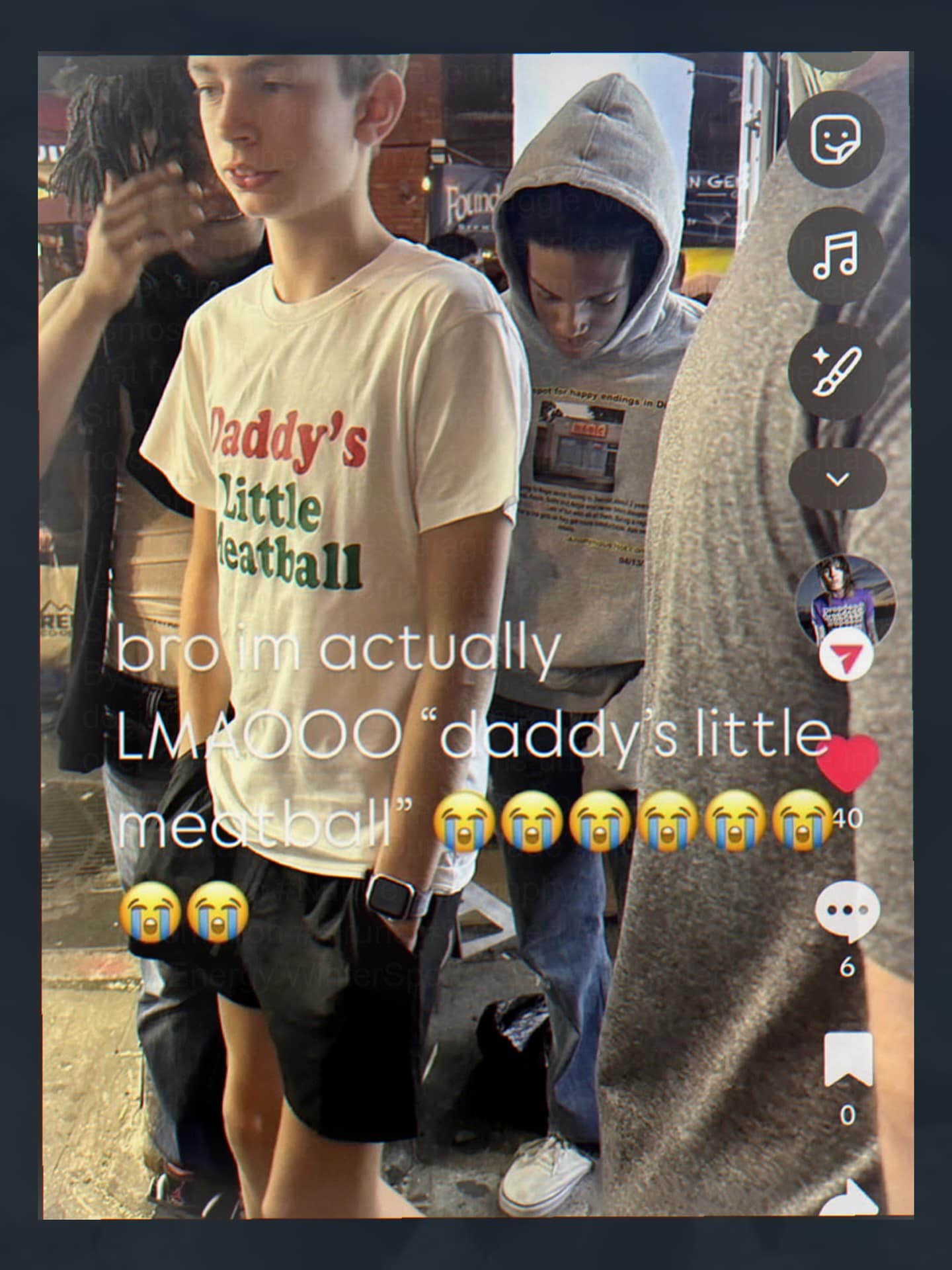 meme dump photo of a teenage boy in a crowded street wearing a shirt that says "Daddy's Little Meatball" in colorful font.