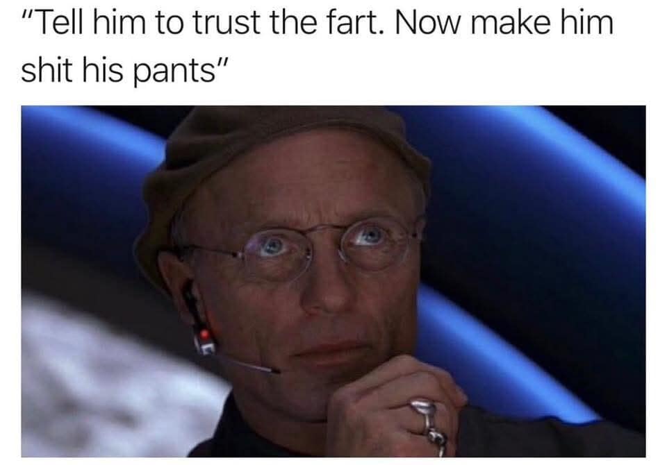 A darkly comedic movie edit in this funny meme features Ed Harris directing a live broadcast from The Truman Show booth, paired with a chaotic, juvenile prank text overlay.