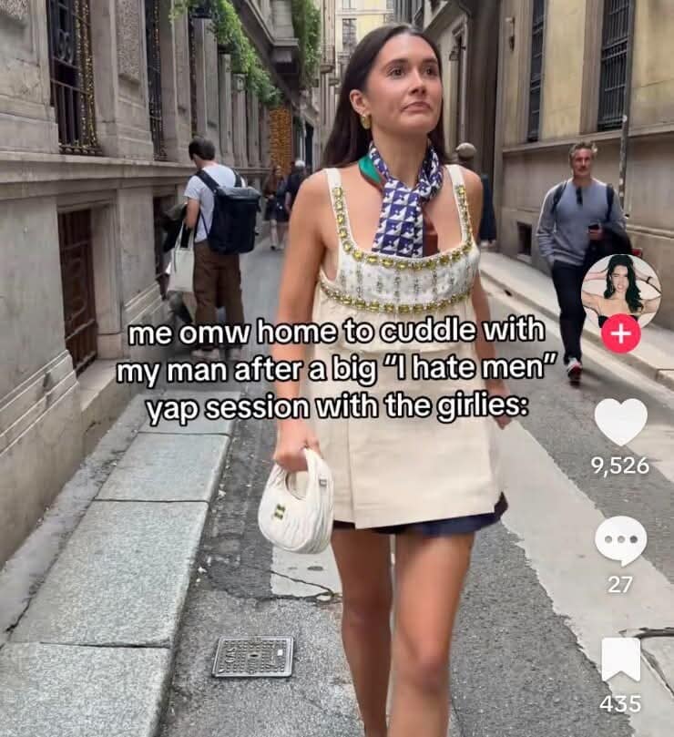 A relatable meme dump photo of a woman in a fashionable outfit walking confidently down an alley. The text reads: "me omw home to cuddle with my man after a big 'I hate men' yap session with the girlies."