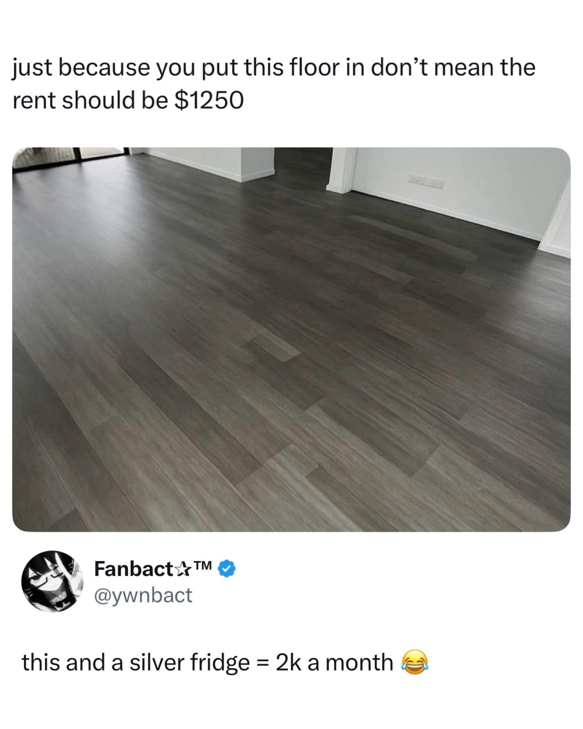 A relatable housing crisis meme dump entry showing a generic photo of gray-toned "luxury" laminate flooring, captioned about how this specific floor and a stainless steel fridge somehow justify $2,000 a month in rent.
