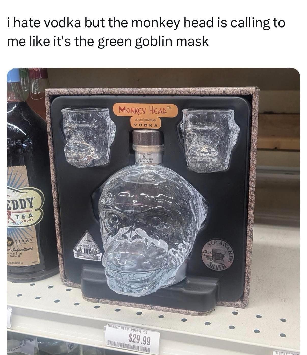 A liquor store display shelf showcases a box gift set of "Monkey Head Vodka" featuring a massive glass bottle sculpted like a chimpanzee skull alongside two matching skull glasses in an entertaining meme dump entry.