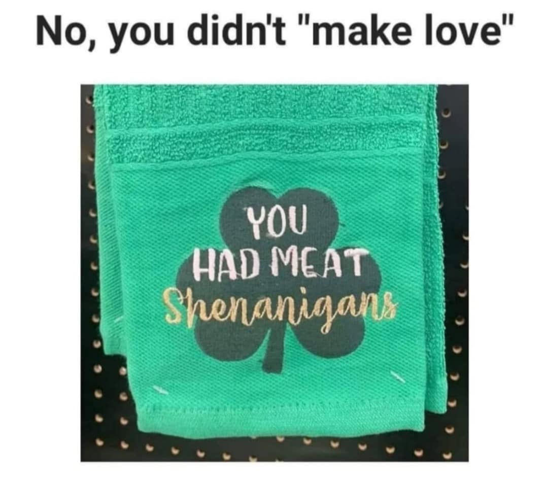 A green St. Patrick's Day-themed hand towel that reads "YOU HAD MEAT Shenanigans" in gold script, humorously subverting the phrase "made love."