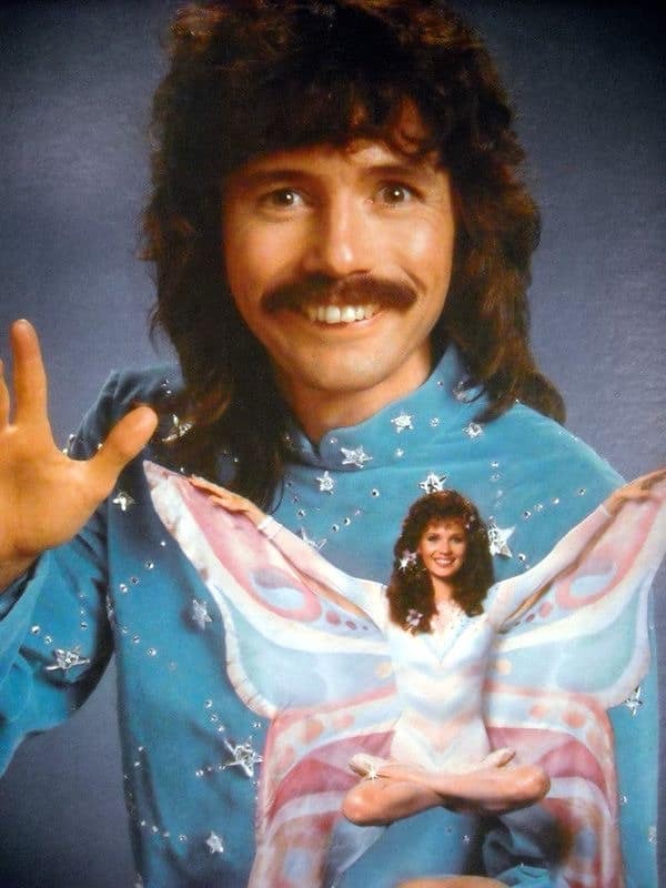 An absurdist meme dump visual featuring a retro 80s-style glamour shot of a man with a mullet and mustache, with a smaller, translucent woman-butterfly figure superimposed over his chest in a lotus position.