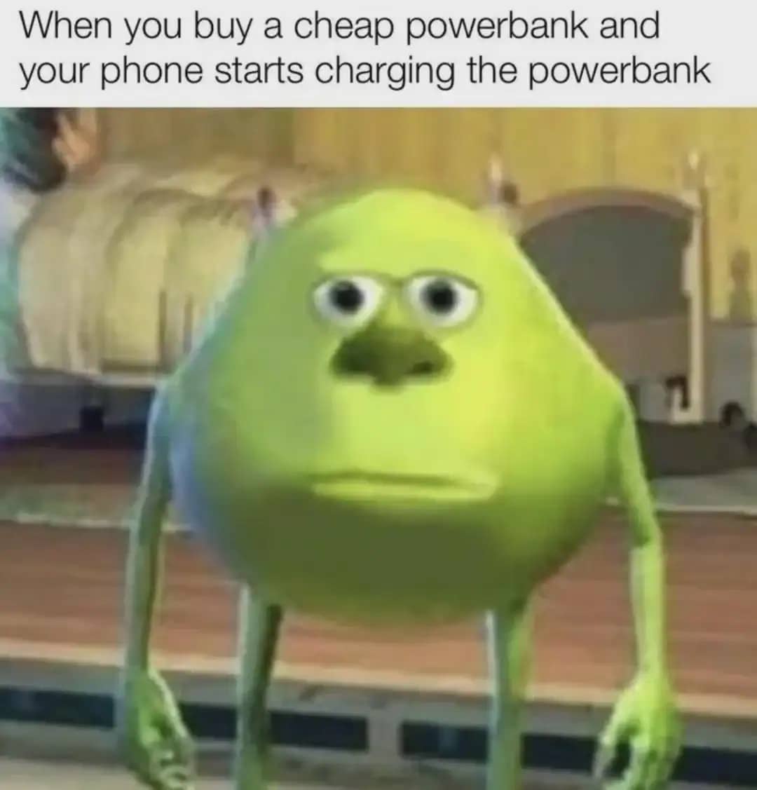 Mike Wazowski with a deadpan face expression about a phone charging a cheap powerbank.