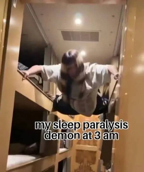 A person braced between bunk bed frames representing a scary sleep paralysis demon at 3 am.