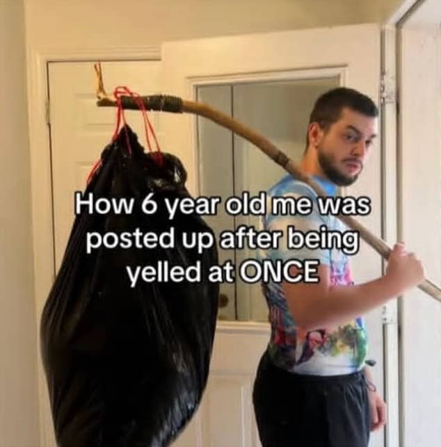 Man holding a trash bag on a stick as a makeshift bindle after being yelled at.