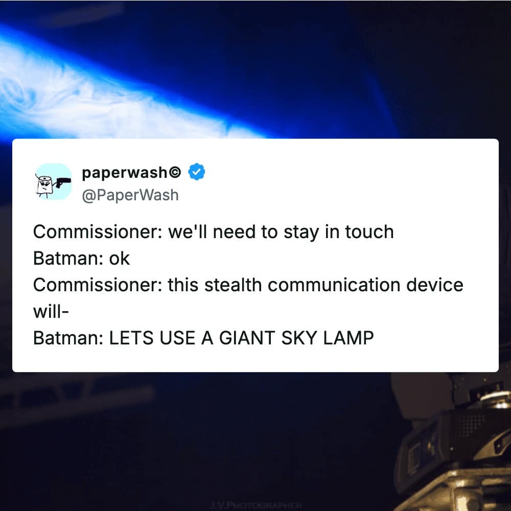 A text-based movie meme parodying the logic of Batman’s stealth tactics, showcasing a mock dialogue where the Commissioner suggests a subtle communication device, only for Batman to aggressively demand a giant sky-pointing spotlight instead.