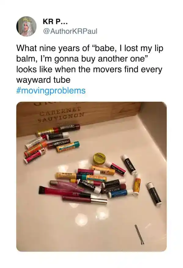 Collection of lost lip balm tubes found during a move scattered on a white surface.