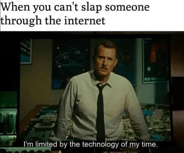 A tech-irony nerd meme utilizes an official movie screenshot of Howard Stark from Iron Man 2 delivering his famous line "I'm limited by the technology of my time," re-contextualized under a caption about the pure frustration of being unable to physically slap someone through an internet browser interface.
