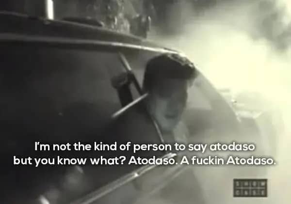 A blurry black and white photo of a man looking out of a car window.