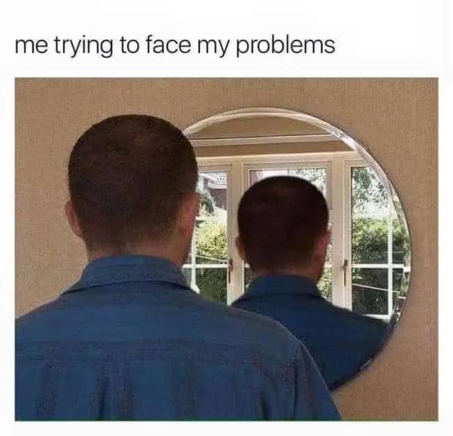 A man looking into a round mirror that only shows the back of his head, illustrating avoiding problems.