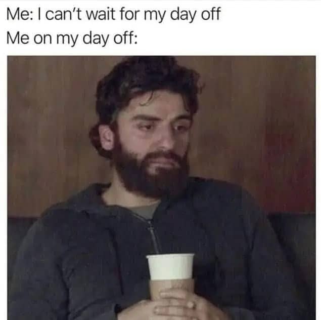 Actor Oscar Isaac looking tired and depressed while holding a coffee cup, representing a wasted day off.