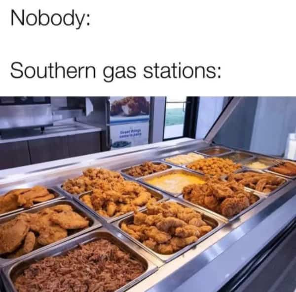 Large heated display case at a gas station filled with various types of fried chicken.