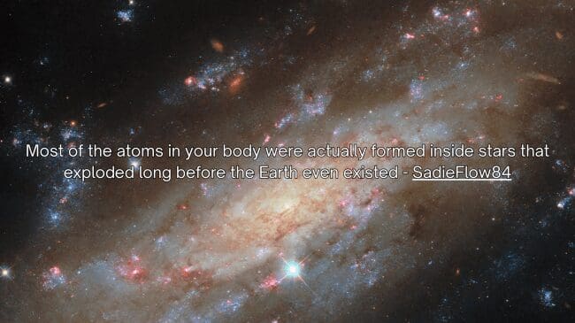 An exquisite view of a glowing deep space spiral galaxy frames a humbling space fact shared by SadieFlow84 explaining that most of the physical atoms inside your body were forged in ancient exploding stars.