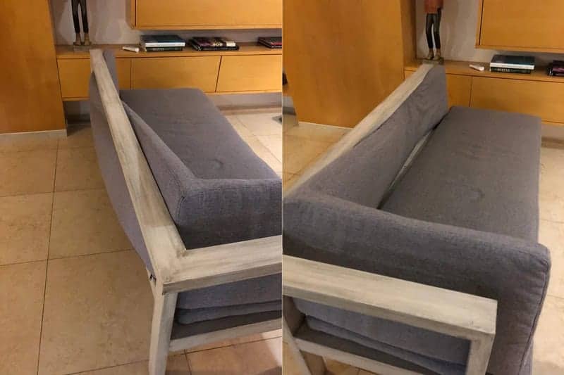 Gray upholstered sofa with a narrow wooden frame built into the seat cushions awkwardly.