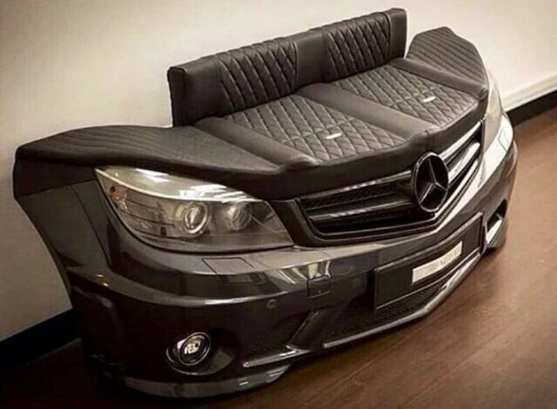 Black leather sofa built into the front end of a gray Mercedes-Benz car.