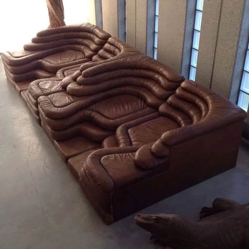 Brown leather sectional sofa with deep, rippling tiers that look like terraced earth.