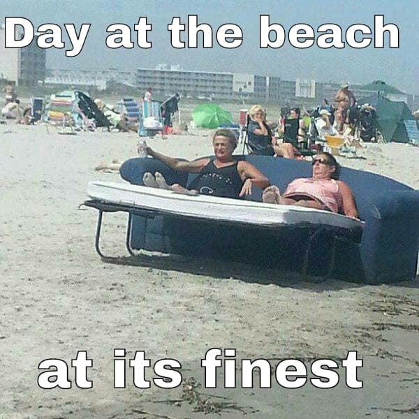 An absolute classic beach meme showcases two elderly women completely skipping out on standard folding lawn chairs to haul a massive, fully upholstered blue living room sofa directly onto the ocean sand under the text, "Day at the beach at its finest."