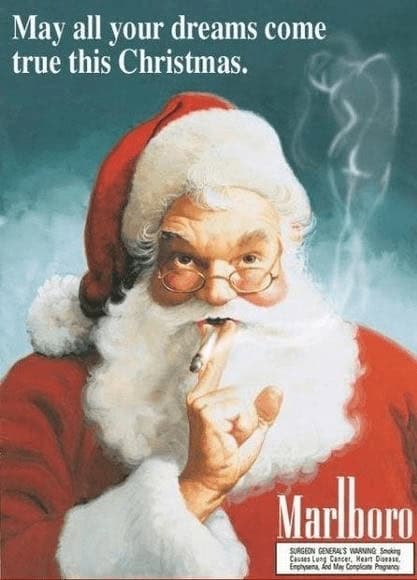 vintage cigarette ad from Marlboro featuring a classic, rosy-cheeked Santa Claus enjoying a cigarette. The text above reads, "May all your dreams come true this Christmas," while Santa looks through his spectacles with a relaxed, knowing expression.