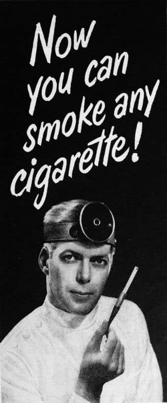 A stark black-and-white vintage cigarette ad featuring a man in medical gear with a head-mirror holding a filtered cigarette holder, under the headline "Now you can smoke any cigarette!"