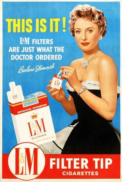 A classic vintage cigarette ad for L&M Filter Tip cigarettes featuring actress Barbara Stanwyck in a black evening dress. The bold text declares, "L&M Filters are just what the doctor ordered," as she holds a pack of cigarettes near her jewelry.