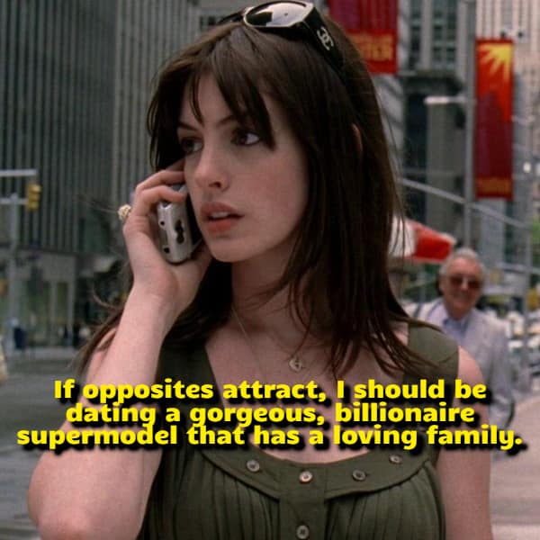 Actress Anne Hathaway talking on a silver flip phone during a city scene from The Devil Wears Prada underscores a bittersweet visual funny shower thought analyzing the flawed logic of romantic attraction.
