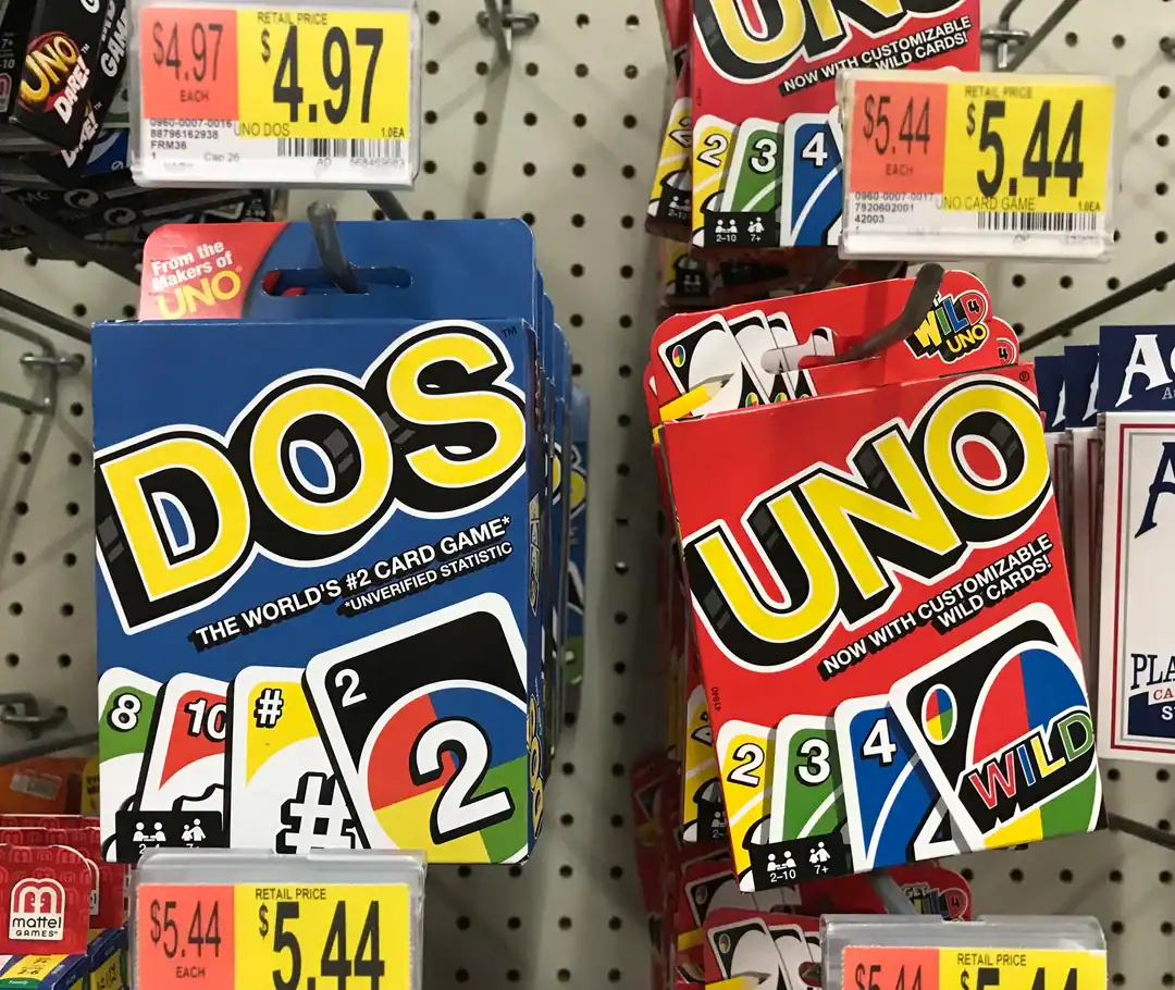 An official but fundamentally weird product on a store shelf: "DOS," the sequel to the card game UNO, featuring the unverified claim that it is the "World's #2 Card Game."