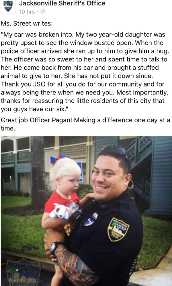 A heartwarming wholesome meme from the Jacksonville Sheriff's Office featuring Officer Pagan holding a toddler who had been upset by a car break-in, after he gifted her a stuffed animal to soothe her fears.