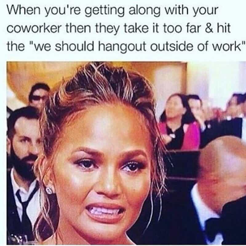 A cringing work meme featuring Chrissy Teigen’s famous award show "grimace" face. The text describes the precise moment an office relationship crosses a terrifying boundary: "When you're getting along with your coworker then they take it too far & hit the 'we should hangout outside of work'."