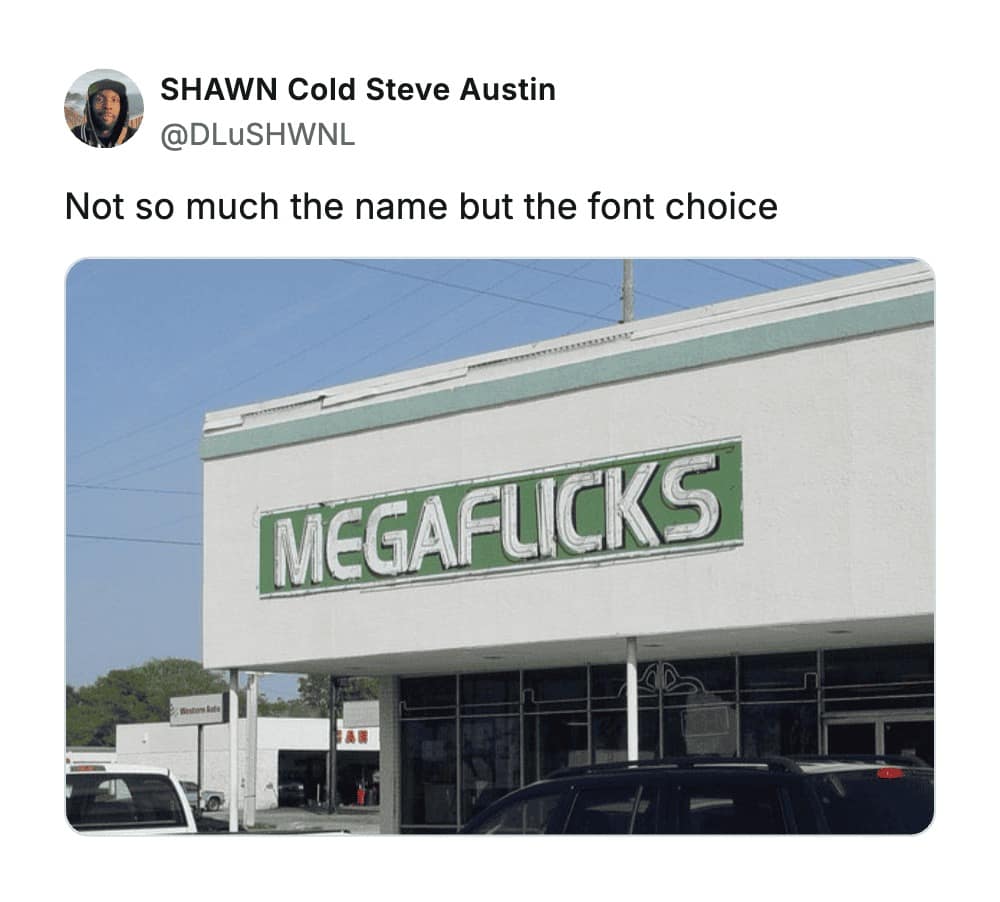 A storefront for "MEGAFLICKS" where a disastrous kerning choice makes the 'L' and 'I' look like a 'U', resulting in one of the most famously vulgar accidents in the history of worst business names.