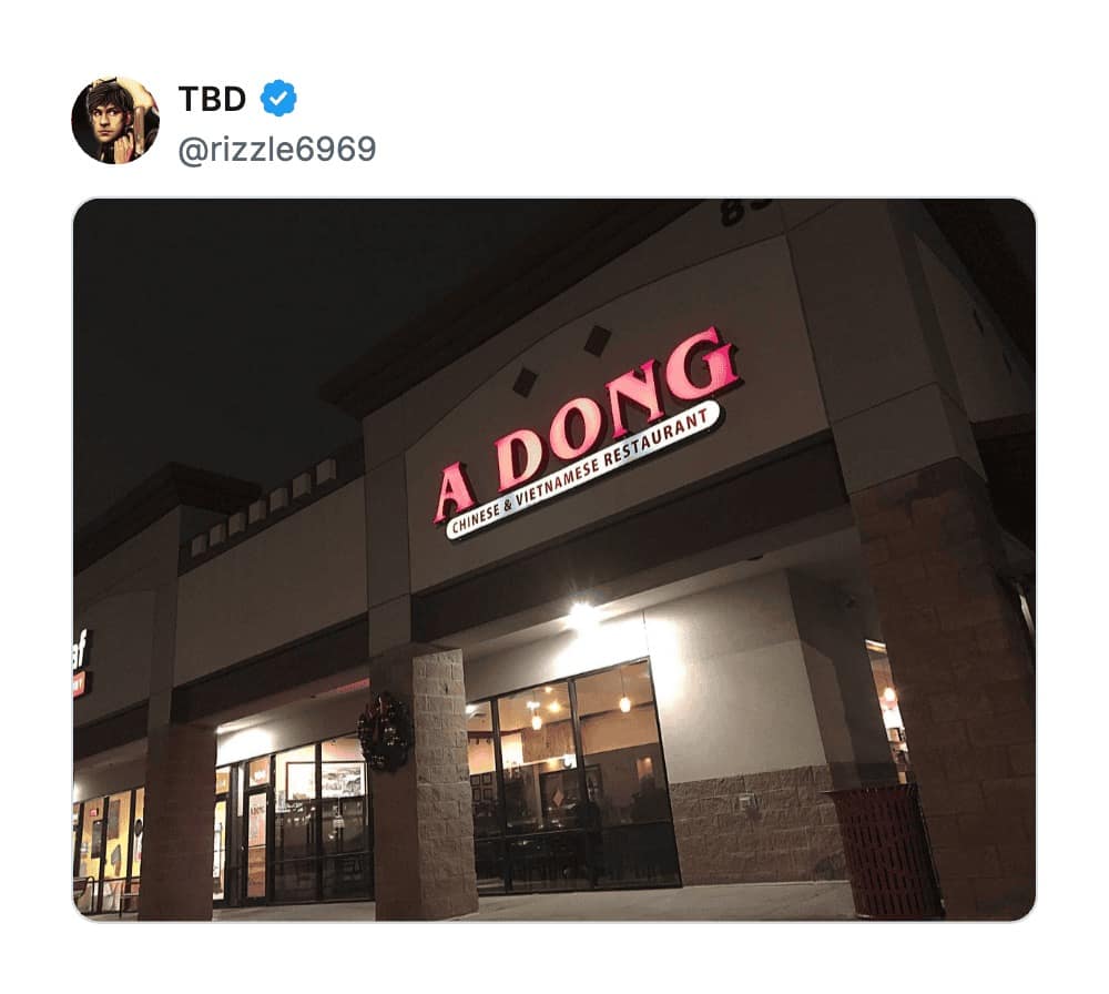 A glowing red neon sign for "A DONG Chinese & Vietnamese Restaurant," which remains a staple of worst business names lists for its unfortunate phonetic impact on English speakers.