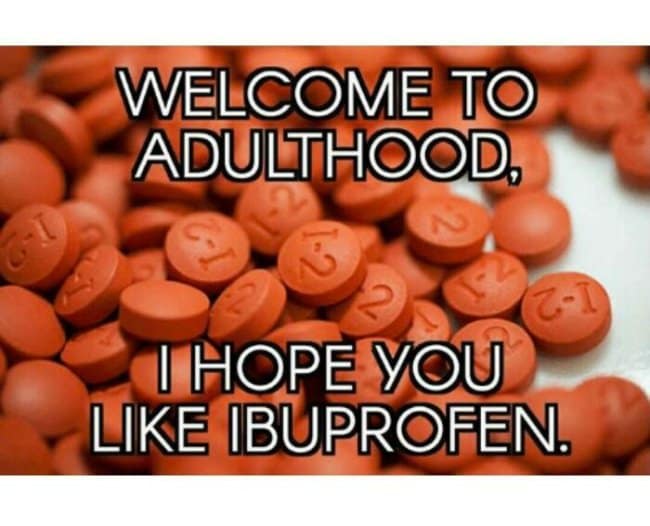 Meme over a pile of orange ibuprofen tablets reads “Welcome to adulthood, I hope you like ibuprofen,” an adulthood meme that reduces grown-up life to back pain, mystery aches, and aggressively practical medicine cabinets.