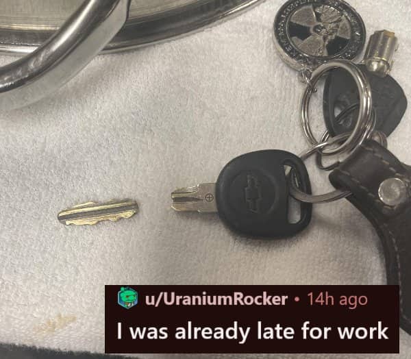 A broken car key snapped in half with a Chevrolet fob lying on a white cloth.