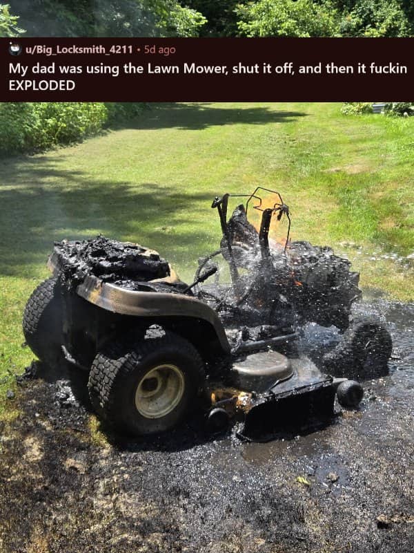 A riding lawn mower completely charred and destroyed by a sudden explosion on a green lawn.