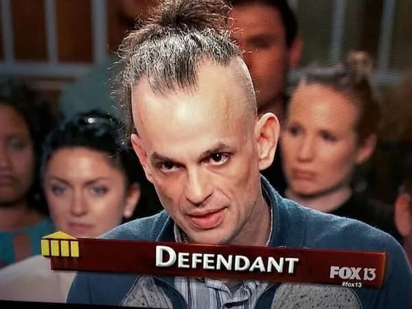 News television broadcast showing a defendant with a chaotic, half-shaved messy top-knot mohawk, representing criminal bad haircuts.