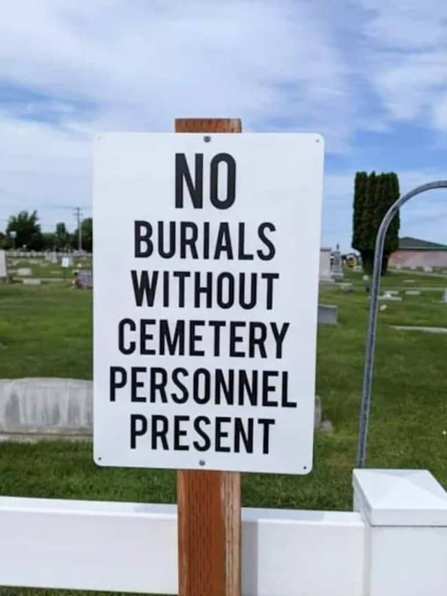 Funny warning sign in a graveyard stating no burials without cemetery personnel present.
