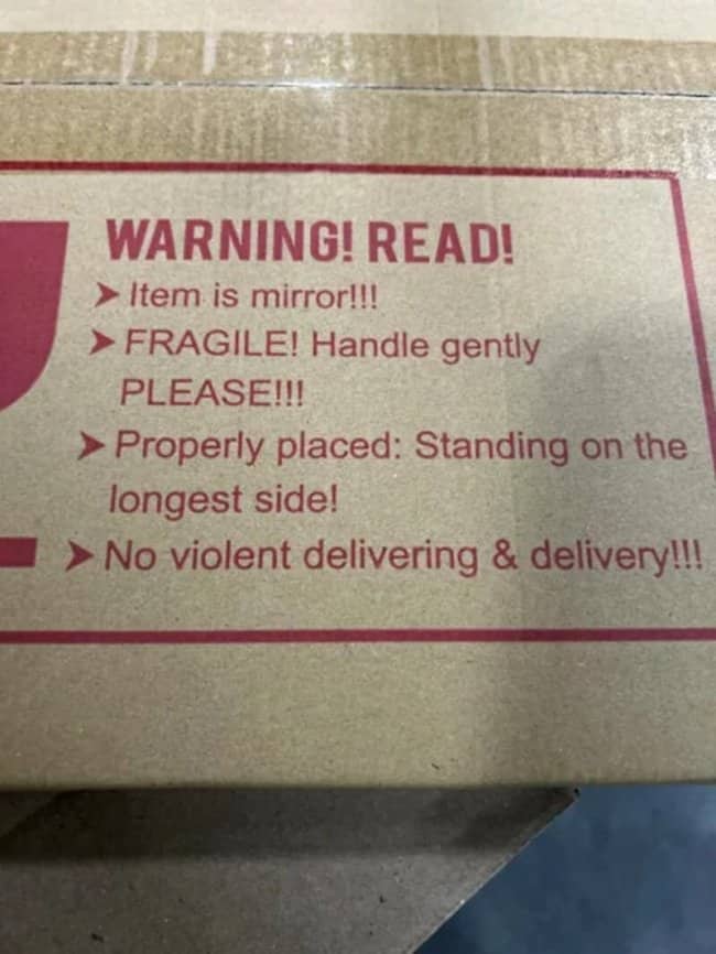 Humorous shipping box warning text demanding no violent delivering and delivery of mirrors.