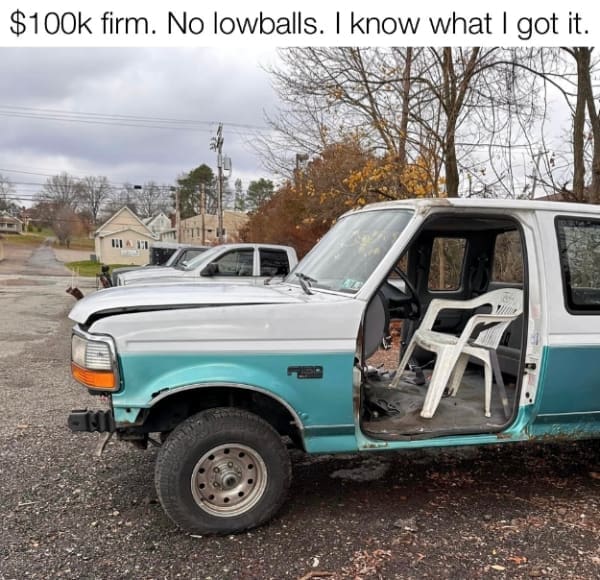 Beat-up old turquoise pickup truck for sale with a white plastic lawn chair substituted as the driver seat.