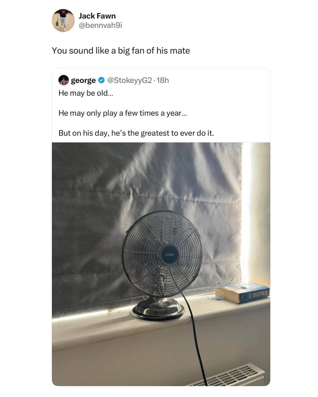 A small desk fan sitting on a window sill next to a closed blind.