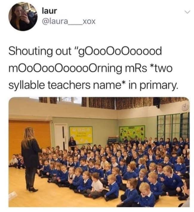 A nostalgic british meme references a mandatory childhood ritual via a viral tweet from laur (@laura___xox). The text reads, "Shouting out 'gOooOoOoooood mOoOoOooooorning mRs two syllable teachers name in primary." The accompanying image features a massive assembly of primary school students in blue uniforms sitting cross-legged on a polished wooden floor, perfectly capturing the uniquely dragged-out cadence of the morning greeting.