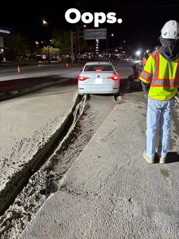 A late-night public works car fail highlights a white sedan that drove straight through a closed construction zone, leaving a massive, deep set of tire trenches down a lane of wet concrete under the caption "Oops."