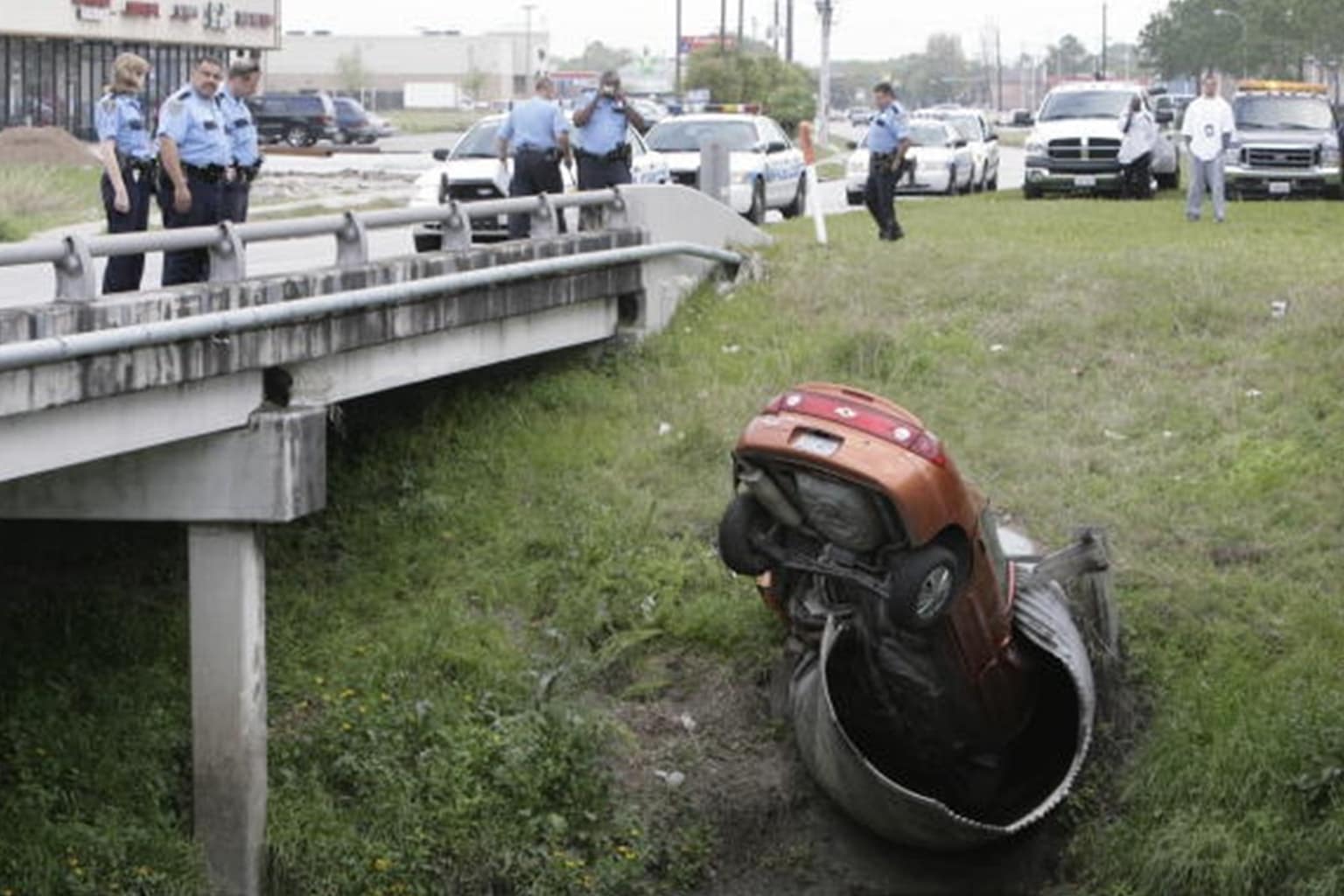 A trending car fails master curation gallery collecting legendary instances of public property damage and vehicular blunders, highlighted by a silver sedan stacking itself like a bunk bed over other luxury cars in a "Members Only" space, an SUV wrapped symmetrically around a barrier pole directly beneath a "Return from Road Test" sign, and a white sedan leaving deep, destructive tire ruts down a freshly poured lane of wet cement.