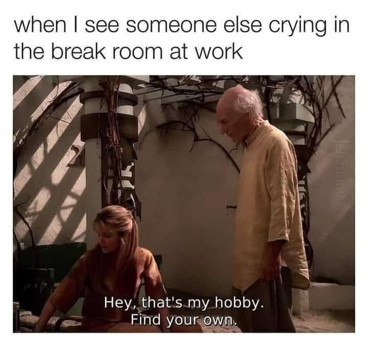 This hilarious workplace classic meme captures a screen grab from a science fiction television show featuring an elderly bald man in a beige tunic approaching a woman. The image is framed by the top header, "when I see someone else crying in the break room at work," with the character's subverted subtitle reading, "Hey, that's my hobby. Find your own."