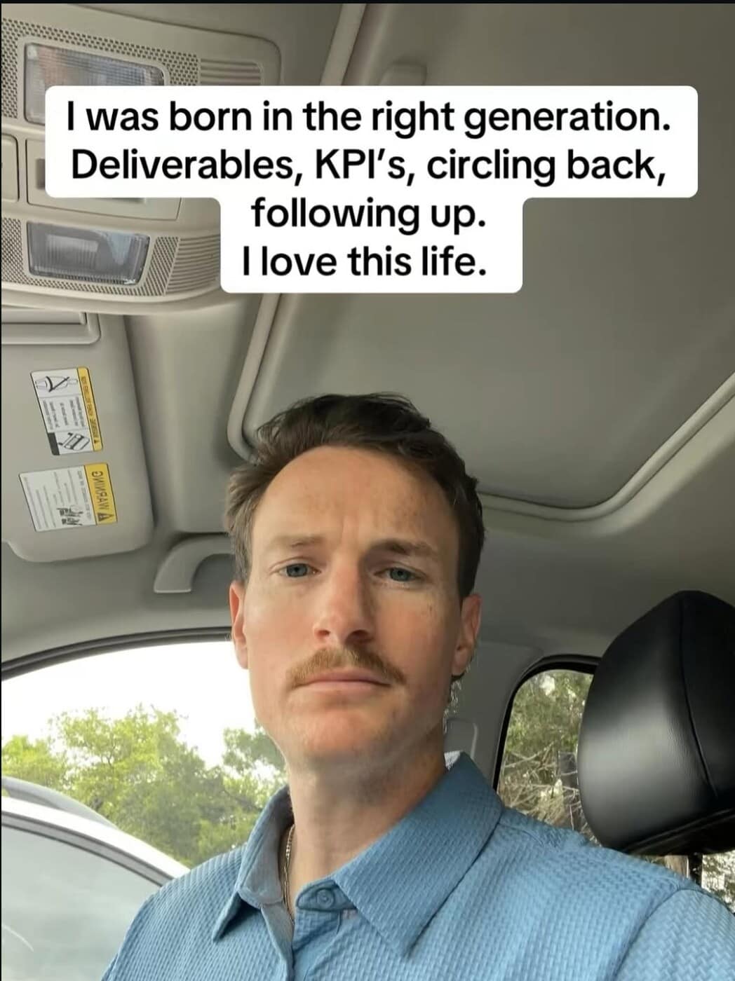 Man with a mustache inside a car under corporate buzzword text macro overlays inside a satirical classic meme.